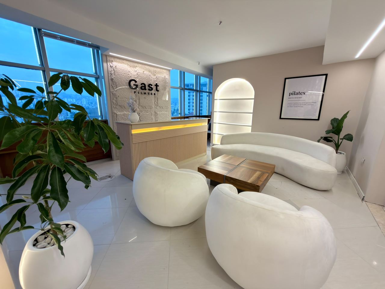 The reception lounge, curved seating and city windows